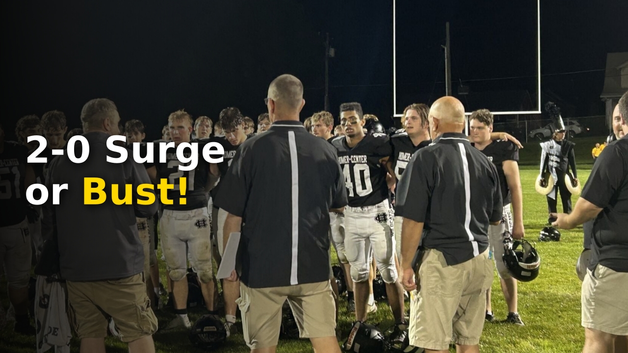 High school football players under the lights during a Heritage Conference Football matchup