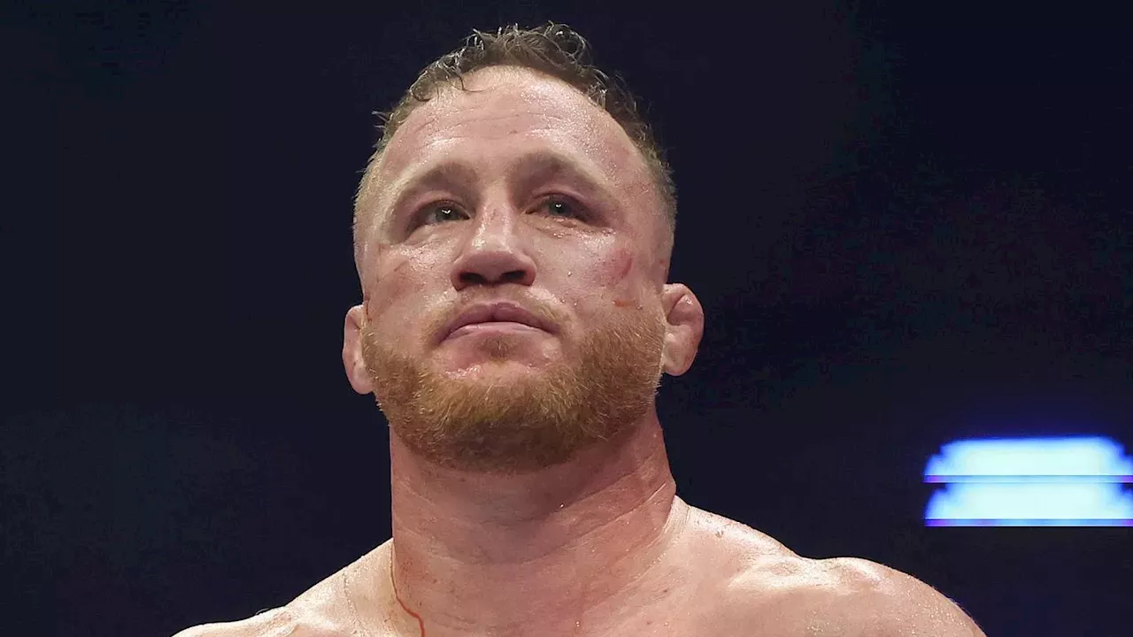Justin Gaethje UFC fight octagon victory celebration holding lightweight championship belt