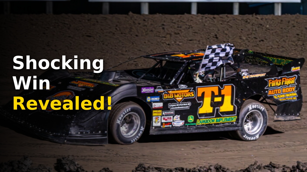 Tom Corcoran posing with a checkered flag after a racing victory