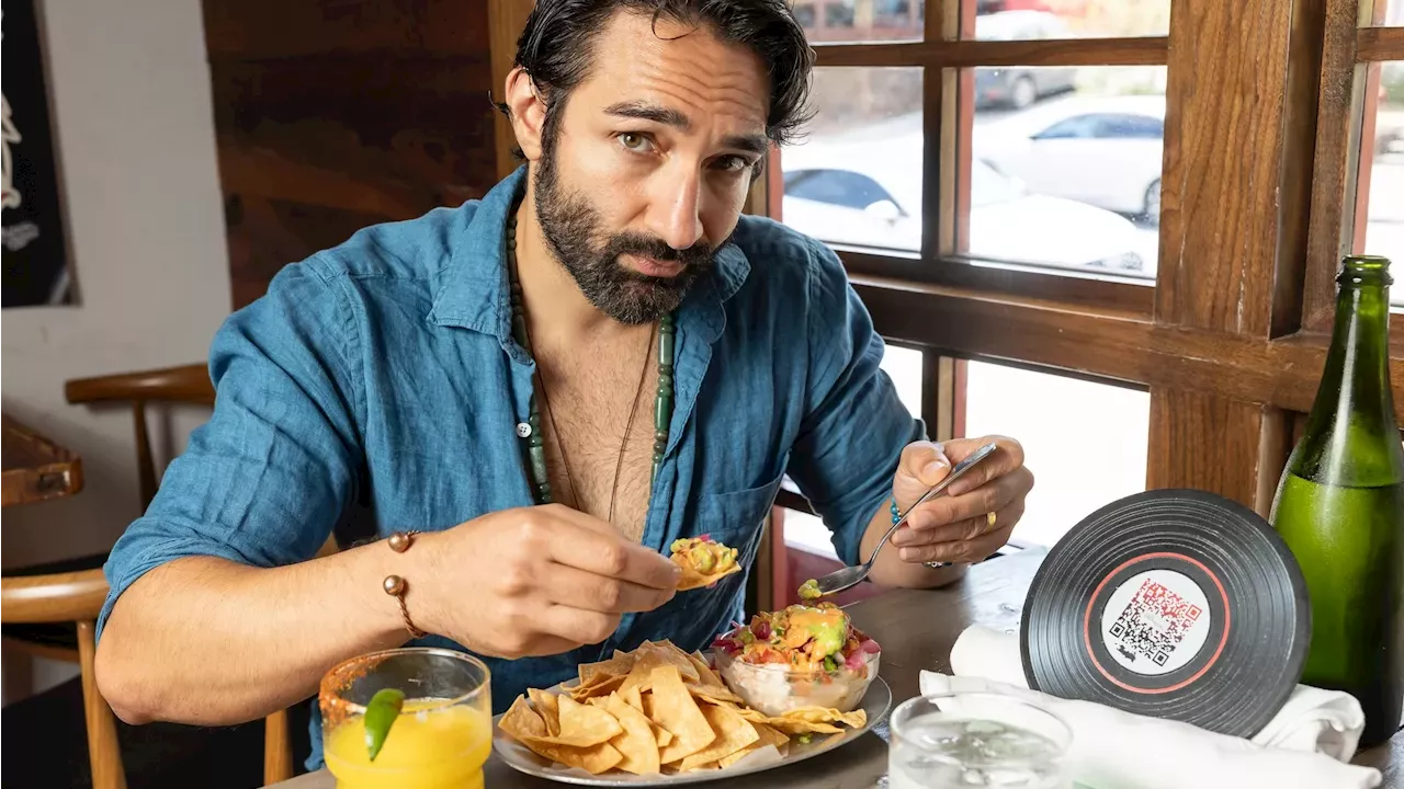 Abe Bueno-Jallad posing in a trendy Bishop Arts neighborhood restaurant