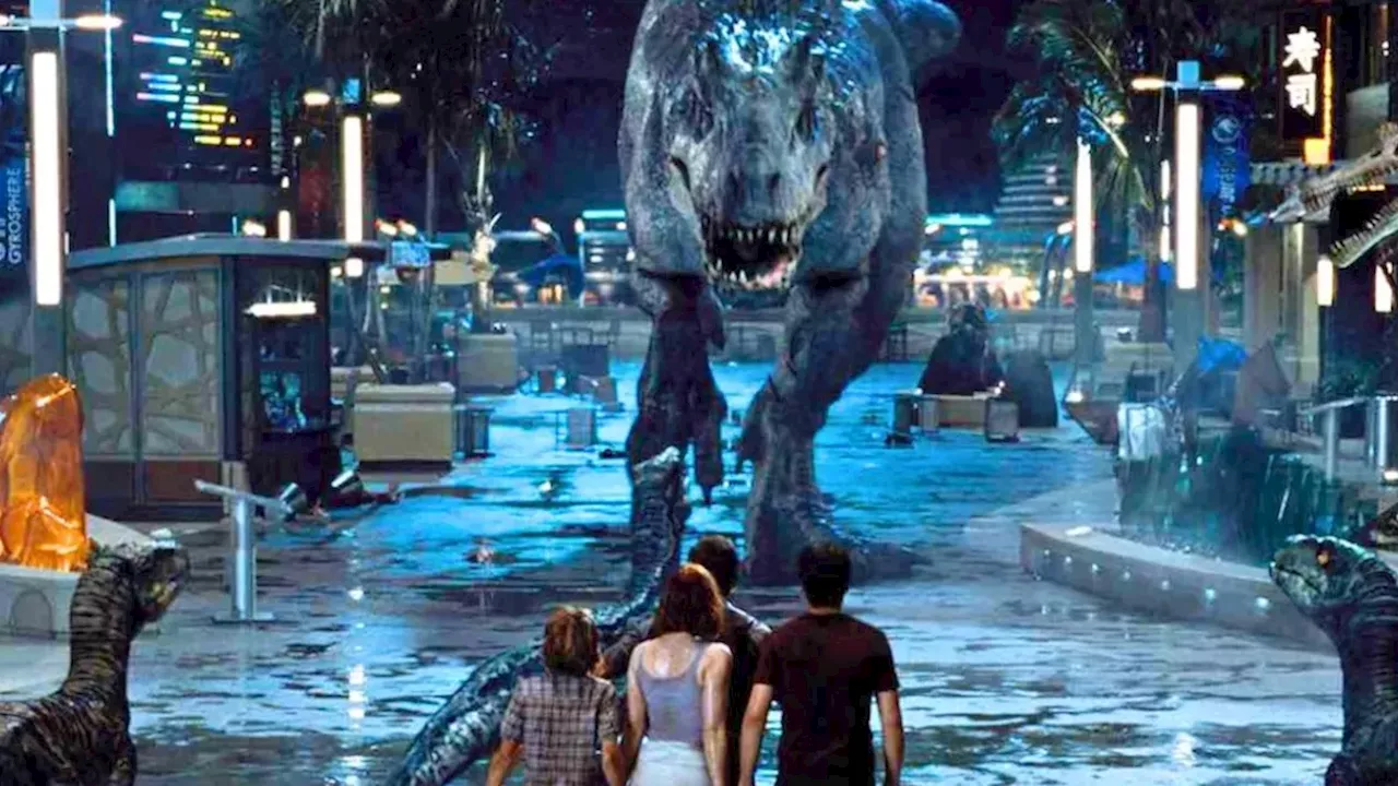 Director Mike Flanagan posing in front of a Jurassic World dinosaur logo