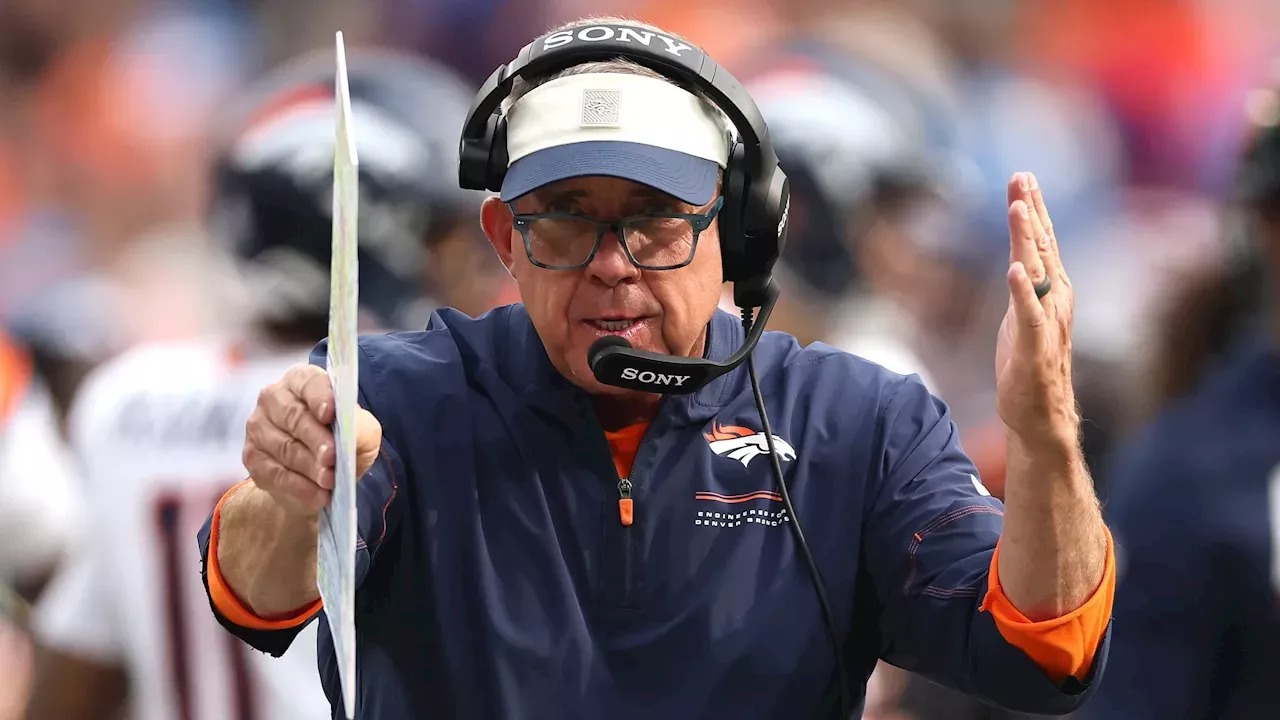 Sean Payton wearing headset and holding play sheet during Broncos game