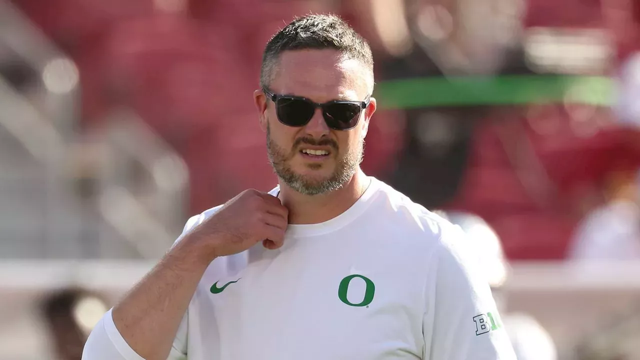 The Oregon Ducks mascot and coaching staff focusing on the recruiting update event